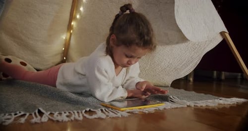 Cute Girl Using Tablet Inside Play Tent