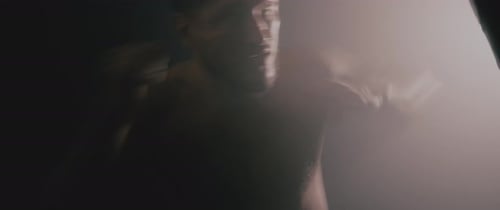 Muscular Man Boxing in a Dark Gym