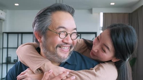 Middle-aged Asian couple smiling for the camera