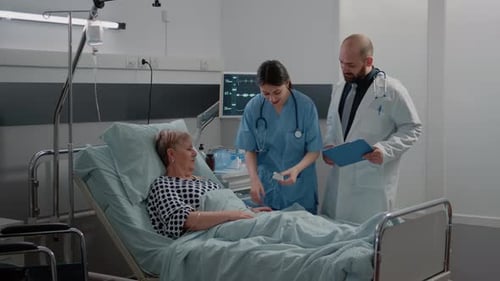 Doctor and Nurse Caring for Senior Patient in Hospital