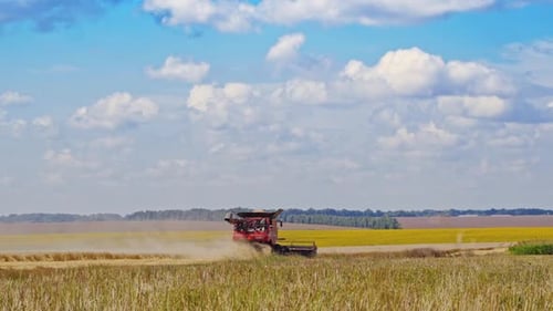 Agricultural machinery working on the field in rural countryside.