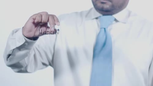 Man Writes Hacking on Clear Surface with Marker