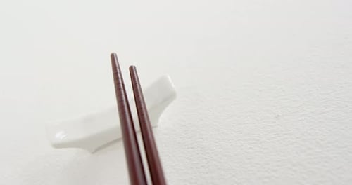 Black chopsticks on a chopstick rest