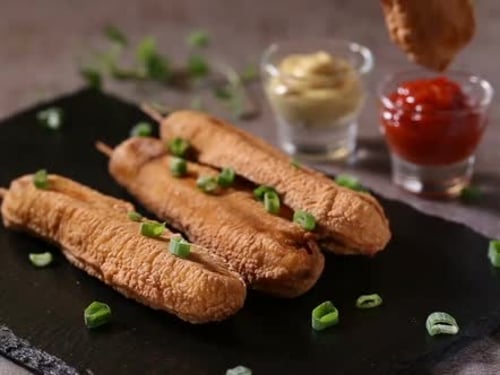 Appetizing Corn Dogs with Ketchup and Mustard