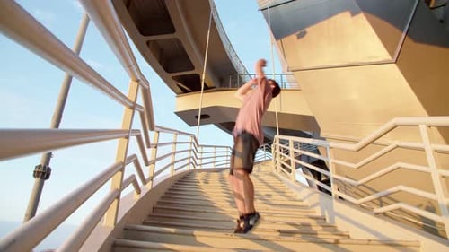 the Athlete Guy Doing a Back Flip on the Stairs Going Up