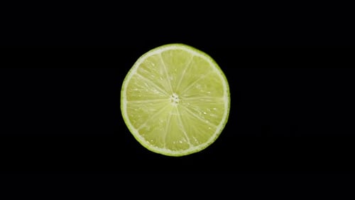 Iolated Lime Cut with a Knife in the Studio on a Black Background