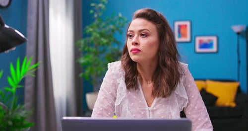 A Young Confused Businesswoman Works Remotely From Home