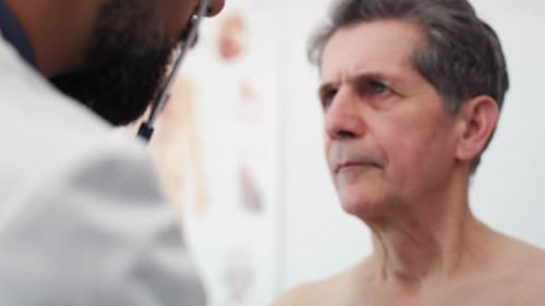 Handheld view of doctor examining his patient. Shot with RED helium camera in 8K