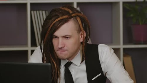 Young Conceptual Man in Business Suit Working at Laptop in Home Office