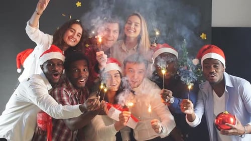 Group of Friends Celebrate Christmas with Sparklers