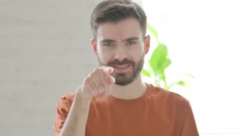 Man Points Finger Directly At Viewer