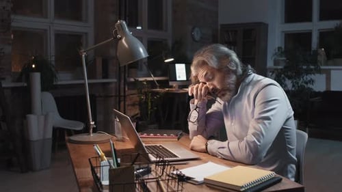 Sleepy Man Working In Office At Night