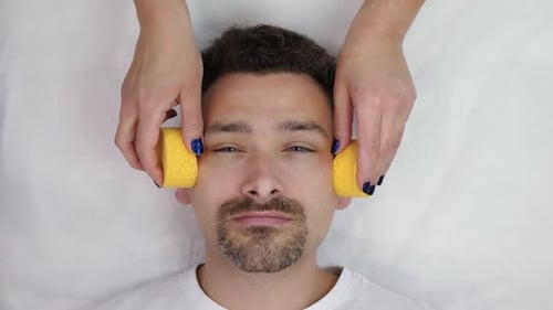 Man Lying Down Having his Face Cleaned