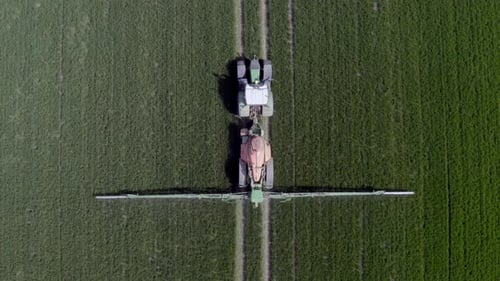 Tractor Sprays Crops From Aerial View