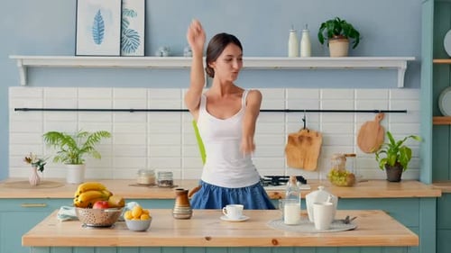 Woman Dancing in Kitchen Having Fun
