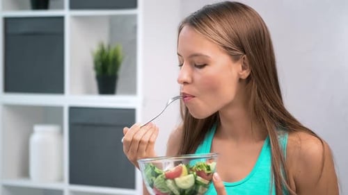 Young Adult Eats Healthy Salad Indoors