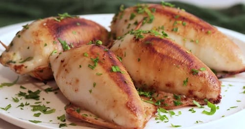 Stuffed Squid Seasoned with Parsley on a White Plate