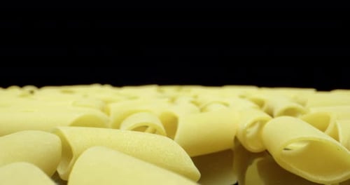 Close-up of Uncooked Pasta Tubes on Black