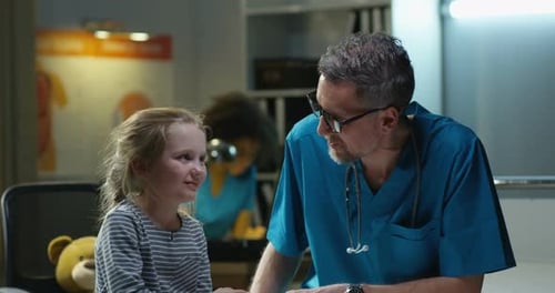 Doctor Talking With a Child in a Medical Office