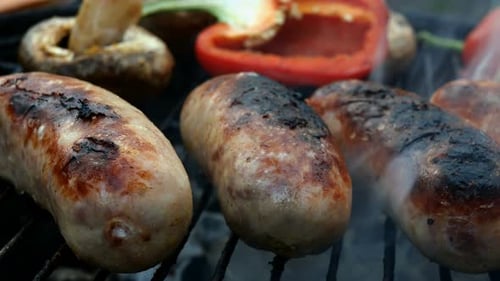 Frying Fatty Bavarian Sausages Cooked on Grill or Barbecue Grid
