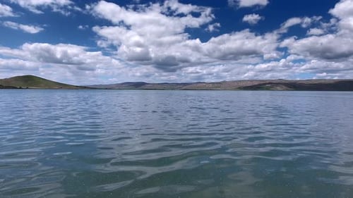 Scenic Lake Landscape With Cloudy Sky and Mountains