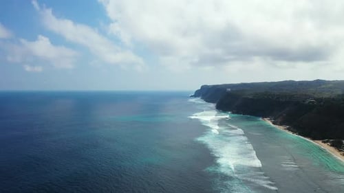 Tropical birds eye tourism shot of a white sandy paradise beach and aqua blue ocean background in co