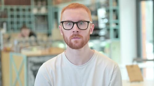 Man Reacts in Shock and Surprise