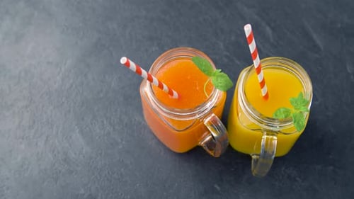Juices in Mason Jar Glasses with Paper Straws