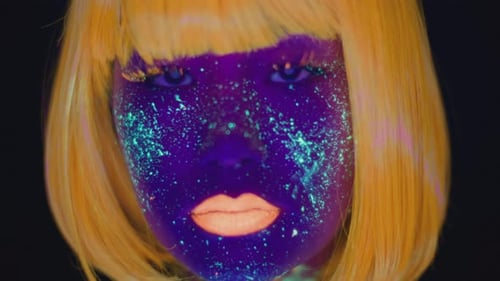 Close Up Portrait of Young Asian Lady with Ultraviolet Space Makeup and Orange Wig and Lips Looking