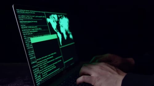 Hands Hacker utiliza el hackeo de una computadora portátil en el cuarto oscuro