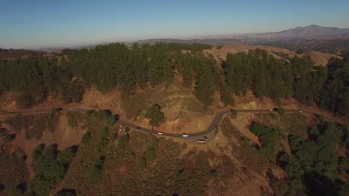 Aerial View of Cars on Winding Mountain Road