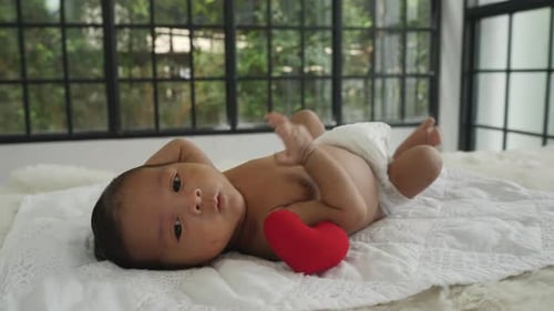 Sweet Newborn Baby Lying Near Red Heart