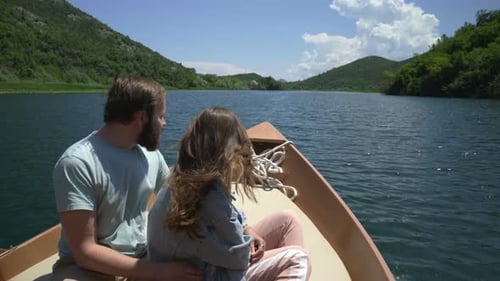 Couple Enjoying a Motor Boat Ride on the Lake