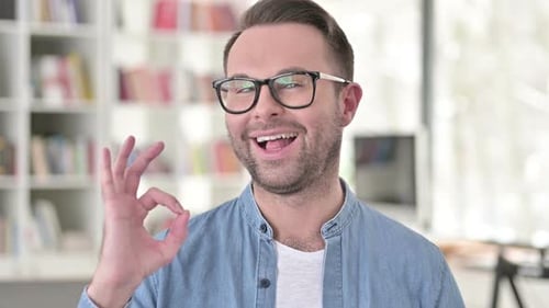 Cheerful Man Shows Okay Sign With a Smile