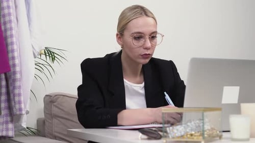 Professional Woman Working at Desk with Laptop