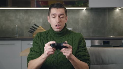 Young Adult Man Playing Video Game Indoors