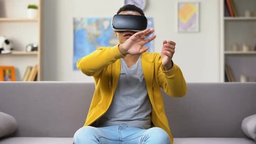 Young Man Exploring Virtual Reality at Home