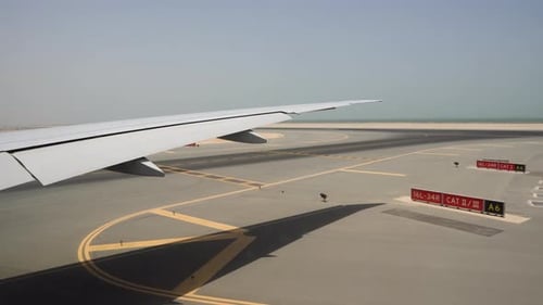 Runway in hot Sunny weather, view through the aircraft window