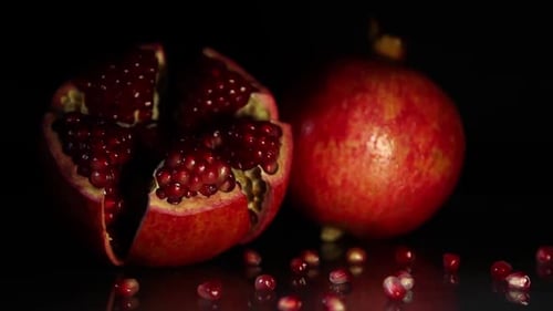 Dramatically Lit Pomegranates on a Dark Background
