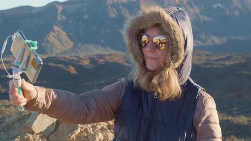 Woman Takes Selfie in Mountains with Smartphone