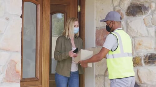 Woman Receives Package from Delivery Driver