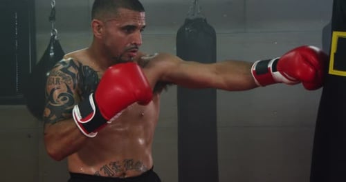 Young Boxer Trains Punching Bag At Boxing Club 36