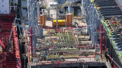 Liquid Cargo Transporter Ship Unloading Crude Oil to a Fuel Depot