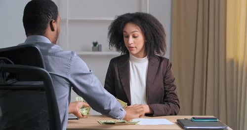Business Partners Work in Office Share Money for Successful Project Investment Curlyhaired Afro