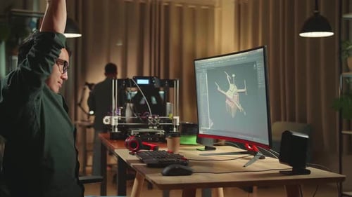 Asian Engineer Stretching While Work On Personal Computer And 3D Printer, Screen Shows Cad Software