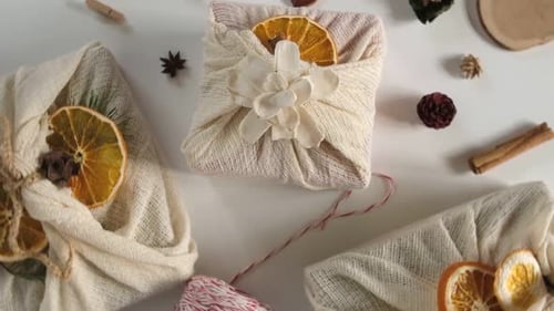 Gifts Wrapped with Cream Colored Cloth and Fruit