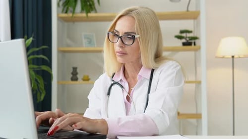 Woman Doctor Working on Laptop in Office