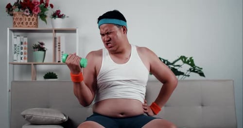 Man Working Out With Dumbbell At Home