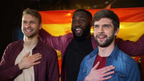 Three Smiling Men Singing with a Flag
