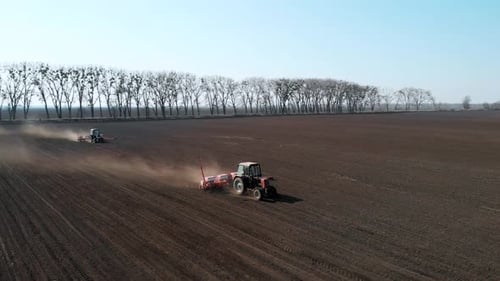Circular overflight around the tractor working in the field